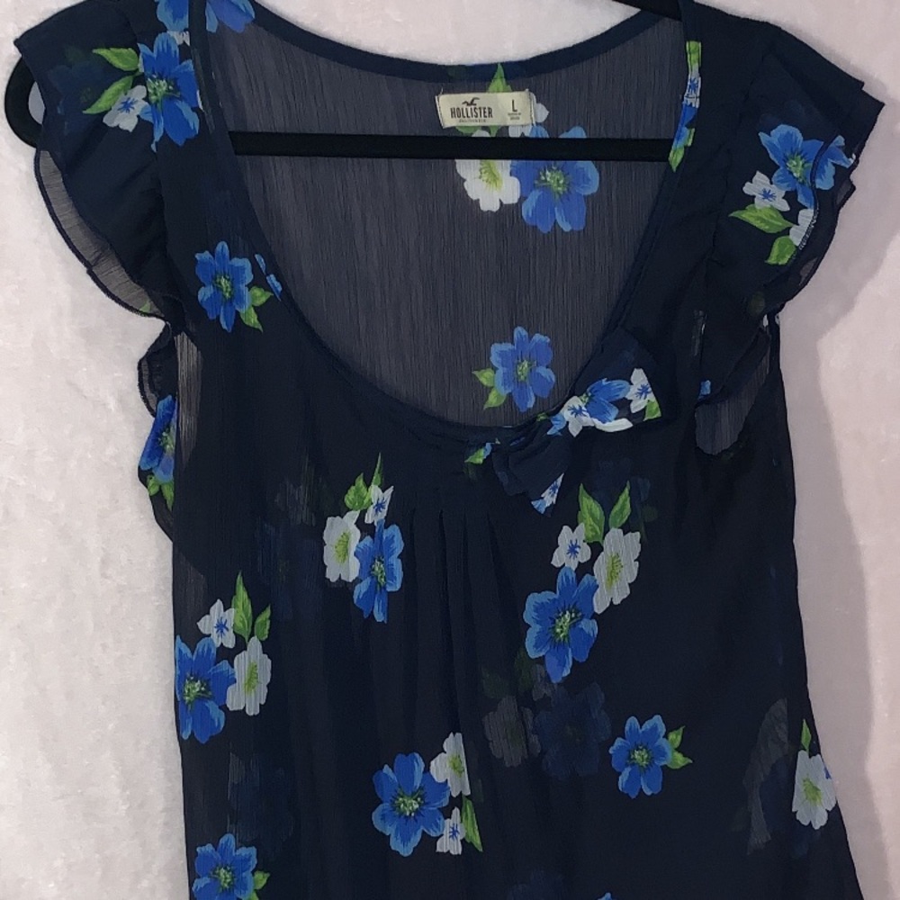 Sheer blue floral print with bow on the front.